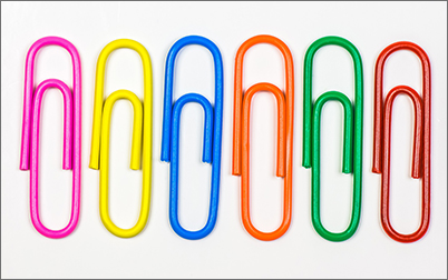 Six paperclips of different colours in a line