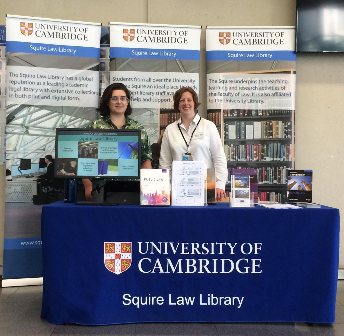 Squire Law Library team members with display stand