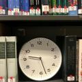 Clock on library book shelf 
